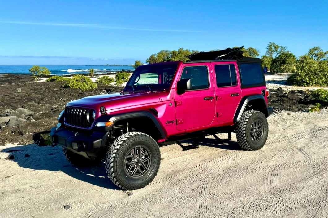 Lifted Jeep Wrangler Willys driving on lava road on the Big Island of Hawaii